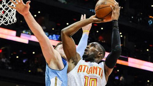 Atlanta Hawks guard Tim Hardaway Jr. (10) goes to the basket against the defense of Denver Nuggets center Jusuf Nurkic, of Bosnia, during the first half of an NBA basketball game, Thursday, March 17, 2016, in Atlanta. (AP Photo/John Amis)