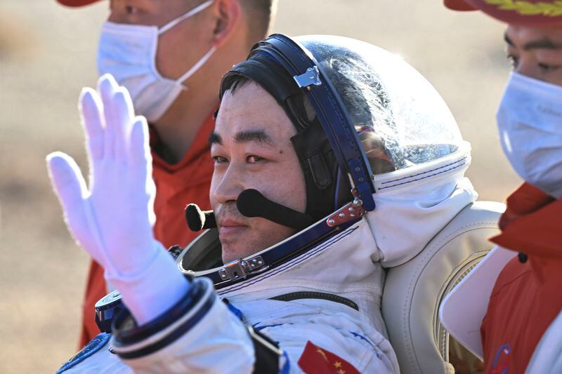 In this photo released by Xinhua News Agency, Chinese astronaut Tang Shengjie waves as he is carried out of the re-entry capsule of the Shenzhou-17 manned space mission after it landed successfully at the Dongfeng landing site in northern China's Inner Mongolia Autonomous Region,, Tuesday, April 30, 2024. China's Shenzhou-17 spacecraft returned to Earth Tuesday, carrying three astronauts who have completed a six-month mission aboard the country's orbiting space station. (Bei He/Xinhua via AP)