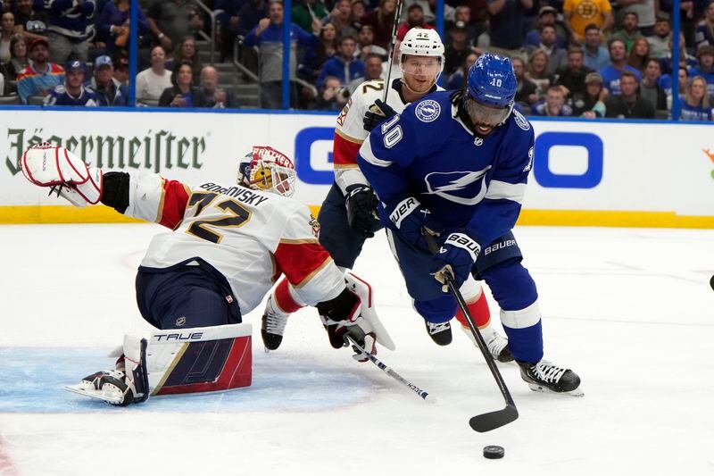 Tampa Bay Lightning left wing Anthony Duclair (10) picks up a loose puck in front of Florida Panthers defenseman Gustav Forsling (42) and goaltender Sergei Bobrovsky (72) during the second period in Game 3 of an NHL hockey Stanley Cup first-round playoff series, Thursday, April 25, 2024, in Tampa, Fla. (AP Photo/Chris O'Meara)