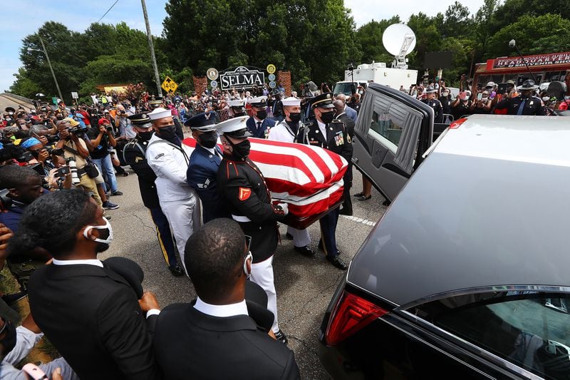 Armed forces personnel transfer the body of Rep. John Lewis to a hearse after making the final crossing over the Edmund Pettus Bridge.   Curtis Compton ccompton@ajc.com