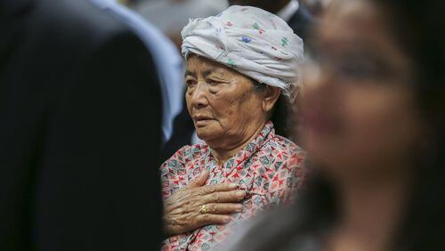 Seventy-one-year-old Ganga Pradhan from Bhutan says the Pledge of Allegiance during Wednesday’s ceremony when 49 people became some of America’s newest citizens. They came from Austria, Bhutan, Bosnia and Herzegovina, Cameroon, Canada, China, Colombia, Ivory Coast, Dominican Republic, El Salvador, Eritrea, Ethiopia, Germany, Ghana, India, Iran, Iraq, Kenya, Mexico, Nigeria, Panama, Peru, Philippines, Romania, Russia, Somalia, United Kingdom, and Vietnam. JOHN SPINK/JSPINK@AJC.COM