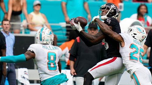 Falcons tight end Kyle Pitts (8) catches a pass between Miami Dolphins cornerback Xavien Howard (25) and free safety Jevon Holland (8) during the second half Sunday, Oct. 24, 2021, in Miami Gardens, Fla. (Wilfredo Lee/AP)