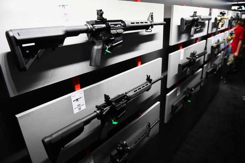 A semi-automatic rifle is displayed on a wall of guns during the National Rifle Association annual meeting in May in Houston. (Patrick T. Fallon/AFP/Getty Images/TNS)