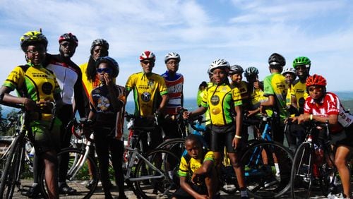 The Dream Team pauses on the road between Rome and Toccoa during the 2018 Bicycle Ride Across Georgia. Leader Atiba Mbiwan is at the center, in the red and white striped bike helmet. CONTRIBUTED