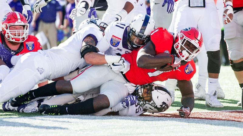 MEMPHIS, TN - DECEMBER 30: Running back Sony Michel #1 of the Georgia Bulldogs falls into the endzone for a touchdown over linebacker Sammy Douglas #35 of the TCU Horned Frogs at Liberty Bowl Memorial Stadium on December 30, 2016 in Memphis, Tennessee. At halftime the TCU Horned Frogs leads the Georgia Bulldogs 16-14. (Photo by Michael Chang/Getty Images)