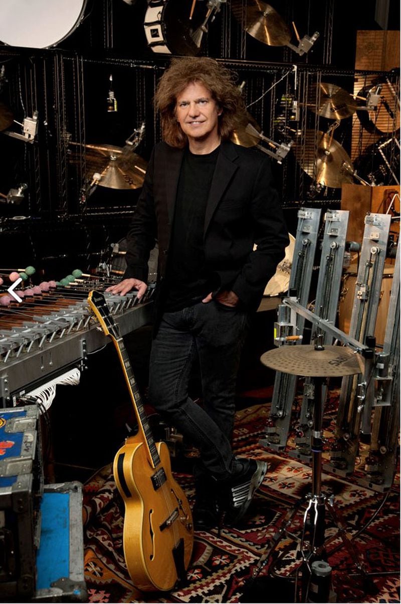 Pat Metheny stands among some of the hardware that he has networked into a controllable one-man orchestra that he calls the Orchestrion.