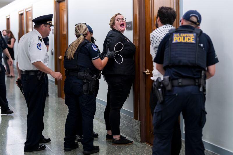 A pro-Palestinian demonstrator is arrested by U.S. Capitol Police officers as activists attempt to disrupt a hearing with Secretary of State Antony Blinken, at the Capitol in Washington, Tuesday, May 21, 2024. (AP Photo/J. Scott Applewhite)