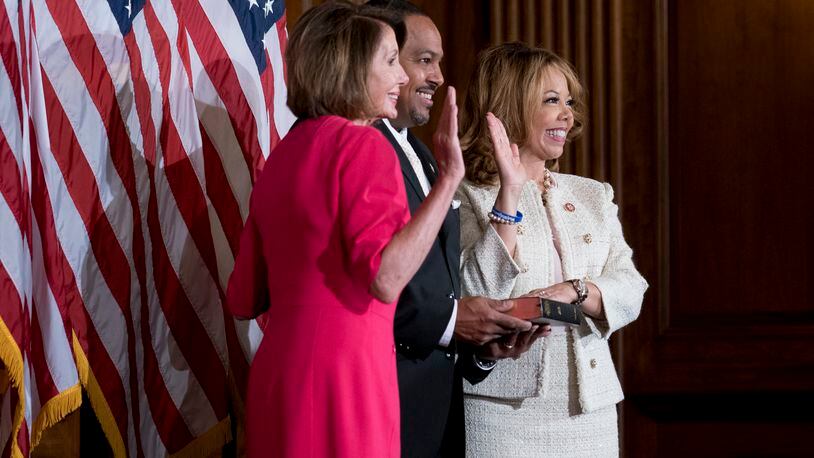 Rep. Lucy McBath (D-Ga.), accompanied by her husband, Curtis McBath, during a ceremonial swearing-in to the 116th Congress with House Speaker Nancy Pelosi (D-Calif.) in the Rayburn Room of the U.S. Capitol in Washington, Jan. 3, 2019. (Erin Schaff/The New York Times)