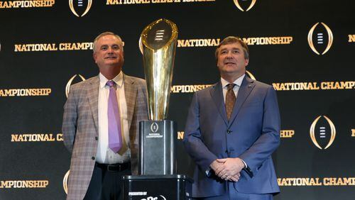 TCU coach Sonny Dykes (left) and Georgia coach Kirby Smart stand next to the National Championship Trophy during the head coaches news conference Sunday in Los Angeles. Georgia plays TCU for the title Monday night in Inglewood, Calif. (Jason Getz / Jason.Getz@ajc.com)