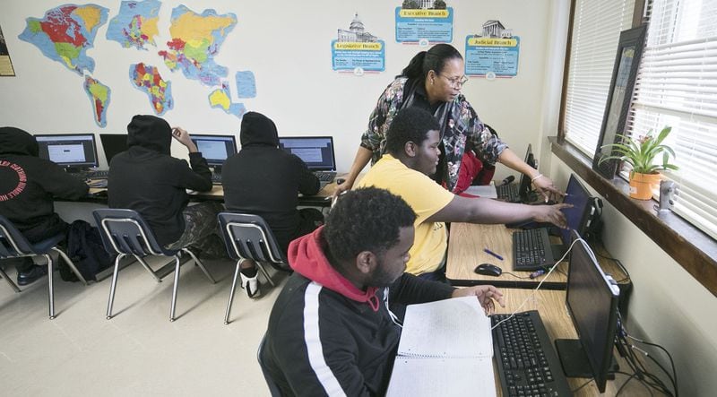 Phoenix Academy Principal Evelyn Mobley checks on students in a social studies class, where the students work independently under supervision on Nov. 12, 2019. BOB ANDRES / ROBERT.ANDRES@AJC.COM