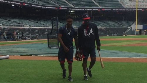 Braves second baseman Ozzie Albies chats with third base coach Ron Washington at SunTrust Park prior to playing the Dodgers on Tuesday afternoon. Albies, 20, debuted as the youngest player in the majors. (Gabriel Burns / AJC)