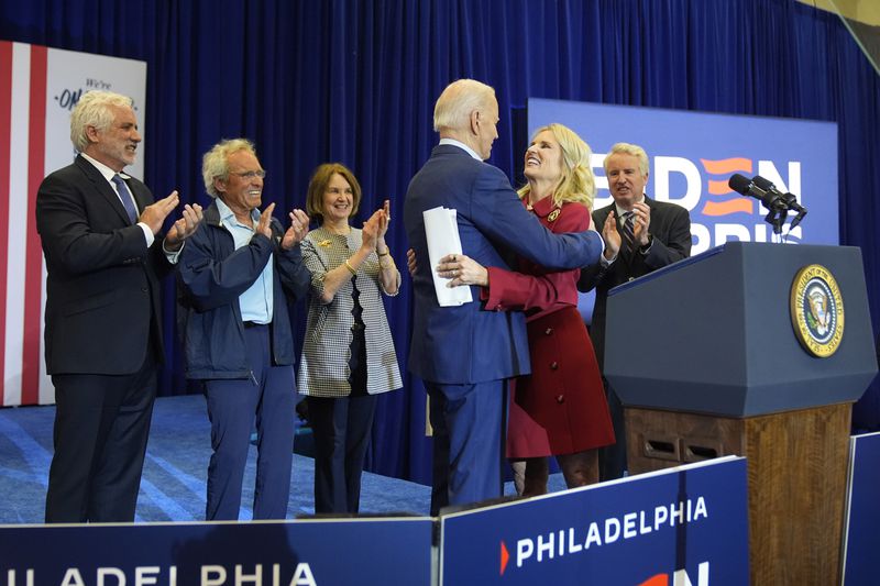 Kerry Kennedy, second from right, hugs President Joe Biden at a campaign event, Thursday, April 18, 2024, in Philadelphia. Pictured from left are members of the Kennedy family Maxwell Kennedy Sr., Joe Kennedy III, Kathleen Kennedy Townsend and Christopher Kennedy. (AP Photo/Alex Brandon)