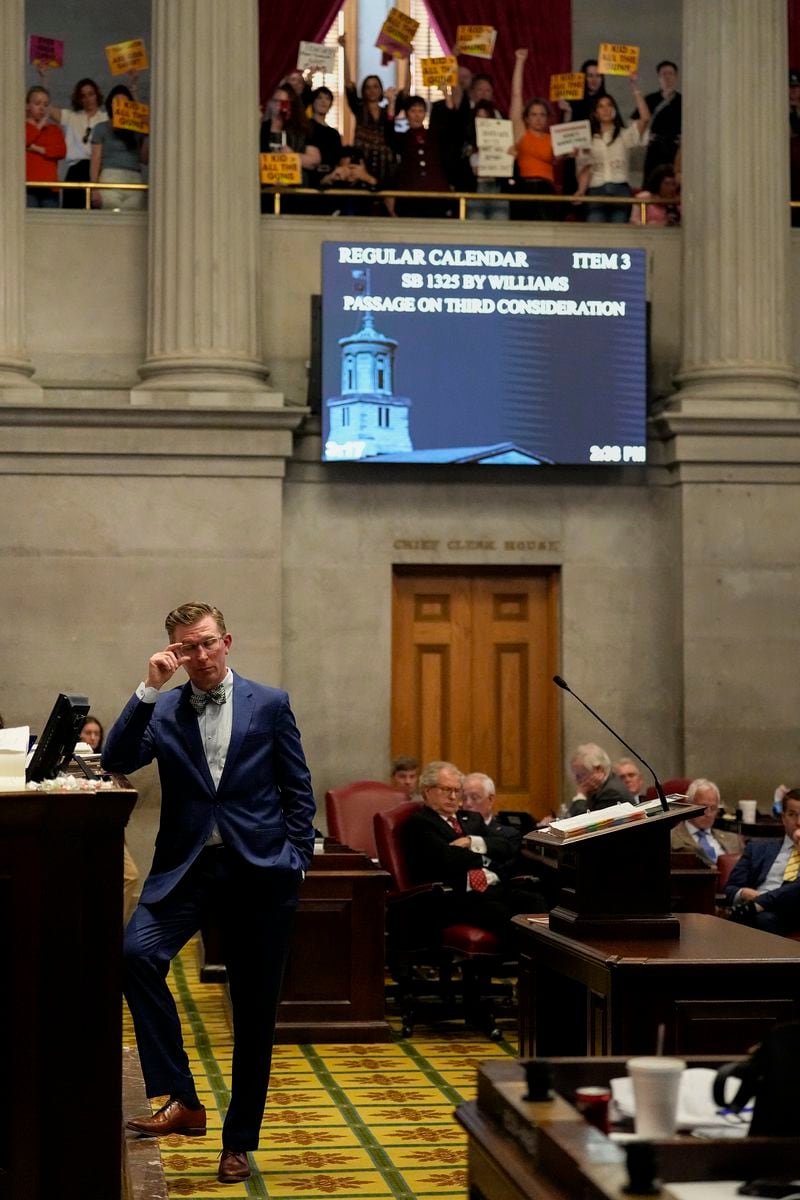 State Rep. Ryan Williams, R-Cookeville, left, listens to debate over his bill to allow some teachers to be armed in school during a legislative session on the House floor Tuesday, April 23, 2024, in Nashville, Tenn. (AP Photo/George Walker IV)