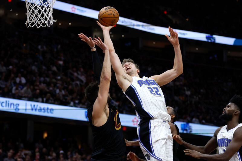 Orlando Magic forward Franz Wagner (22) shoots against Cleveland Cavaliers guard Max Strus during the second half of Game 5 of an NBA basketball first-round playoff series, Tuesday, April 30, 2024, in Cleveland. (AP Photo/Ron Schwane)