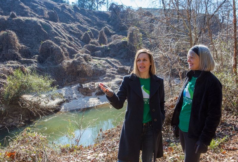 Betsy Eggers and Sarah Kennedy lead a tour of an area in Brookhaven near Buford Highway that will one day become the Peachtree Creek Greenway. (Photo by Phil Skinner)