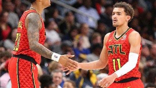 Hawks center John Collins (left) and point guard Trae Young.