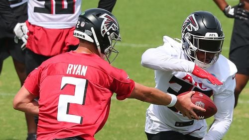 Falcons quarterback Matt Ryan hands off to running back Qadree Ollison (30) while running offensive drills during team practice at minicamp Wednesday, June 10, 2021, in Flowery Branch. (Curtis Compton / Curtis.Compton@ajc.com)