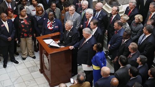A bipartisan group of legislators joined Gov. Nathan Deal for Tuesday's announcement of an income-tax rate cut. (AJC Photo / Bob Andres)