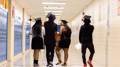 Students walk down the hall after Columbia High School's half-cap ceremony in Decatur on Thursday, May 16, 2024. The ceremony was for sophomores who are on track to graduate in two more years. (Arvin Temkar / AJC)