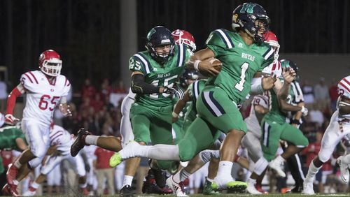 Harrison quarterback Justin Fields (1) runs against Dalton on Thursday, Oct. 19, 2017, in Kennesaw. Fields, rated the nation's top recruit, signed with the Georgia Bulldogs in December and enrolled at UGA in January. (Special to the Atlanta Journal-Constitution, John Amis )