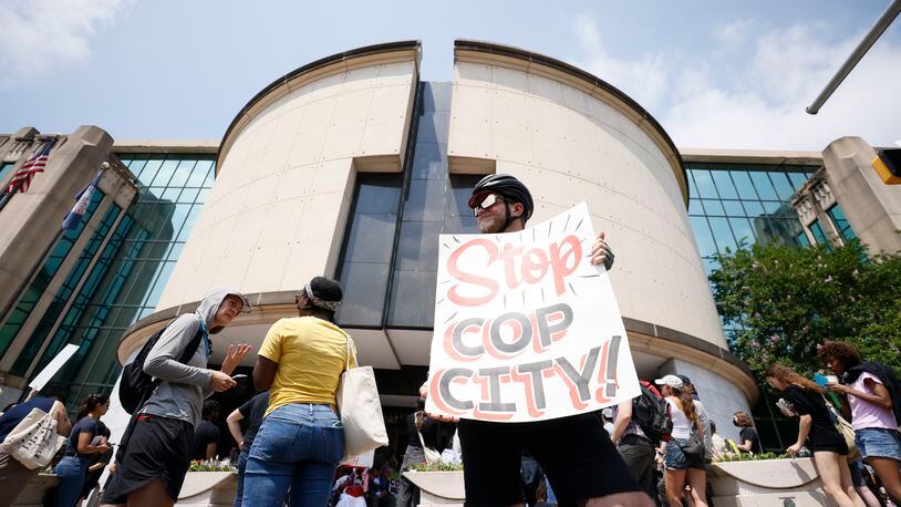 Jacob Croman from Covington held a sign outside the City Hall as they protested the planned Police Training Center on Monday, June 5, 2023.Miguel Martinez /miguel.martinezjimenez@ajc.com