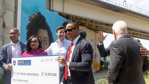 (From left) Assistant Secretary of Transportation for Transportation Policy Christopher Coes, Congresswoman Nikema Williams, Sen. Jon Ossoff, and Atlanta Beltline, Inc. CEO Clyde Higgs, hold up the check for the Atlanta’s Beltline receiving a $25M construction grant on Mayson St. on Monday, July 24, 2023 in Atlanta. (Michael Blackshire/Michael.blackshire@ajc.com)