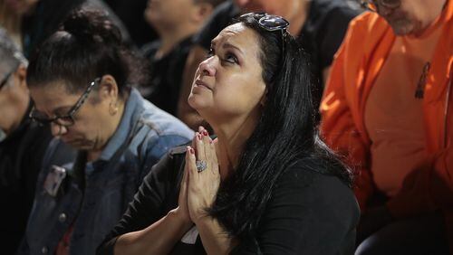 Guests attend a prayer service Tuesday at the La Vernia High School football stadium to grieve victims killed at the First Baptist Church of Sutherland Springs in La Vernia, Texas. Police say Devin Patrick Kelley shot and killed 26 people and wounded 20 others when he opened fire during a Sunday service at the church. SCOTT OLSON / GETTY IMAGES