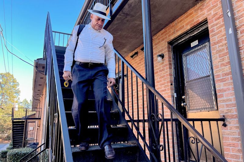 Santiago Murat walks down the front steps of his Atlanta apartment on Tuesday, February 27, 2023. Murat, who had lived on The Hill, one of the biggest homeless encampments in Atlanta, now has an apartment of his own through a program tied to the city. Matt Kempner / The Atlanta Journal-Constitution