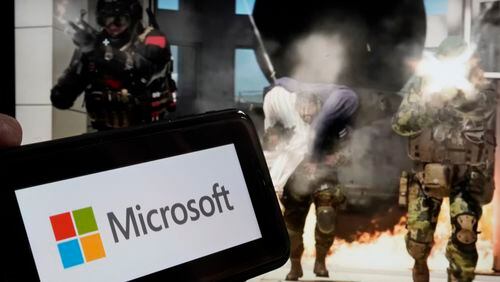FILE - The logo for Microsoft, and a scene from Activision "Call of Duty - Modern Warfare," are shown in this photo, in New York, Wednesday, June 21, 2023. Microsoft reports earnings on Thursday, April 25, 2024. (AP Photo/Richard Drew, File)