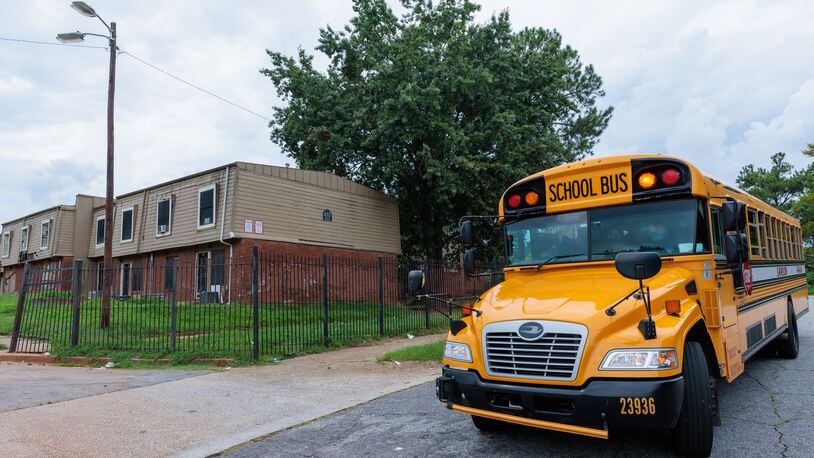 A school bus from Slater Elementary School stops in front of the Forest Cove Apartments in Atlanta on Thursday, August 18, 2022. (Arvin Temkar / arvin.temkar@ajc.com)