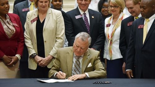 April 21, 2015 Atlanta - Gov. Nathan Deal signs House Bill 372, his plan to allow the state takeover of Georgia’s “failing” schools, at The Georgia State Capitol in Atlanta on Tuesday, April 21, 2015. HYOSUB SHIN/AJC