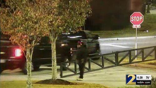 Surveillance video shows a man who appears to be directing the thefts of several trucks from a Newnan dealership.