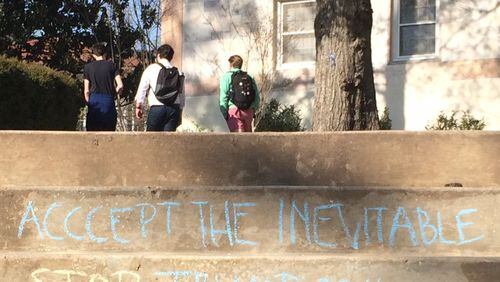 Some in support of Trump has Emory University up in arms. A Trump supporter wrote messages in chalk on the campus last week. An opponent apparently added “STOP” in front of “TRUMP 2016.” Photo by Bill Torpy
