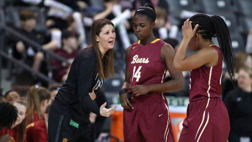 Holy Innocents coach Nichole Dixon (left) talks with Logan Jackson (14) and Jada Farrell (25) in the first half of the GHSA Class A-Private Girls State Championship Friday, March 9, 2018, at McCamish Pavilion in Atlanta.
