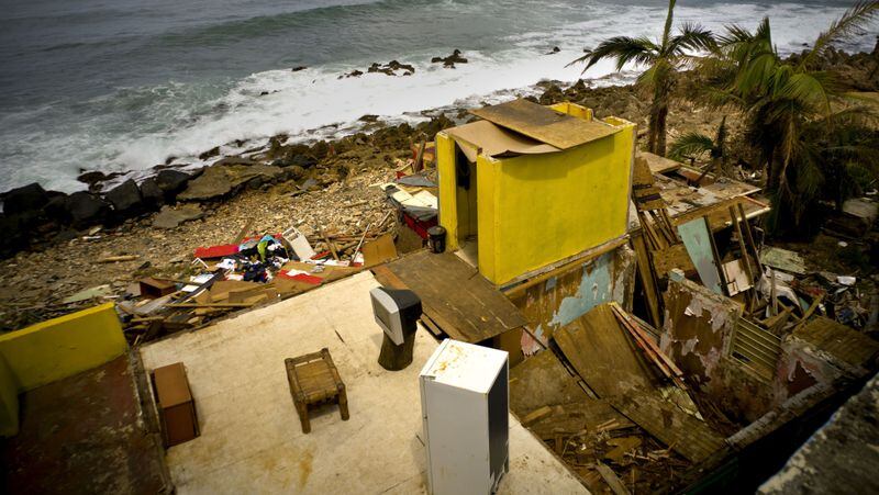 This Oct. 5, 2017 photo shows what is left of Roberto Figueroa's home in the aftermath of Hurricane Maria in the seaside slum La Perla, San Juan, Puerto Rico. Tourism officials recently met with La Perla local leader and asked her how long it would take before La Perla could welcome tourists again. âWe told them to give us a month or two, that we were going to rise up again,â Yashira Gomez said. âWe are looking for any kind of help ... so that tourists can come back and see that La Perla is still pretty, that itâs on its feet and that weâre working hard to make it shine like before.â (AP Photo/Ramon Espinosa)