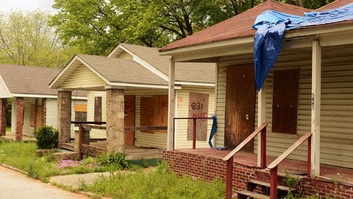 Investors can help stabilize a failing neighborhood, They can also exploit residents’ desire to own a home, according to a Georgia State University professor’s study. Shown here  several years ago are boarded-up properties in the English Avenue area.