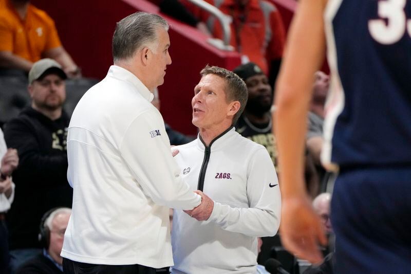 Purdue head coach Matt Painter, left, meets with Gonzaga head coach Mark Few after the second half of a Sweet 16 college basketball game in the NCAA Tournament, Friday, March 29, 2024, in Detroit. (AP Photo/Paul Sancya)