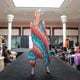 A model wearing a colorful dress struts on the catwalk at the 'Seniors on the Runway' event on May 4, 2024, at Greenbriar Mall in Atlanta.