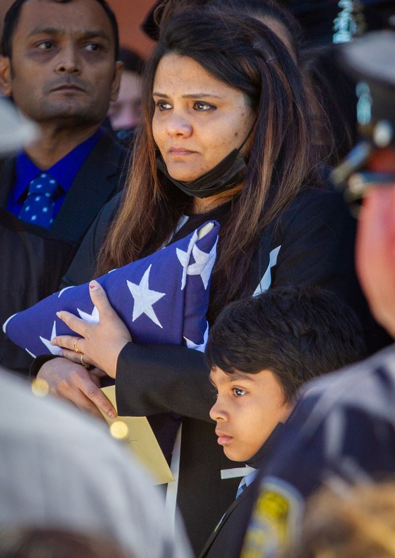 Ankita Desai, the wife of slain Henry County police Officer Paramhans Desai, holds the flag at the funeral service on Sunday, November 14, 2021, at the Henry County Performing Arts Center. (Photo: Steve Schaefer for The Atlanta Journal-Constitution)
