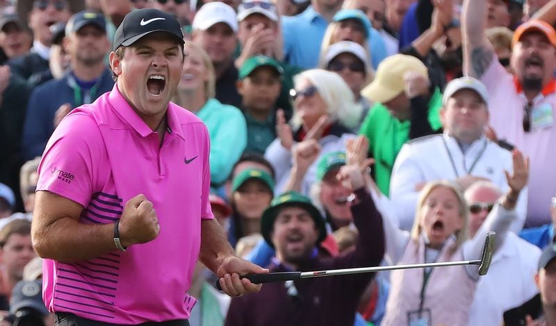 Patrick Reed celebrates his Mastes-winning putt at the 18th hole Sunday, April 8, 2018, at Augusta National Golf Club.