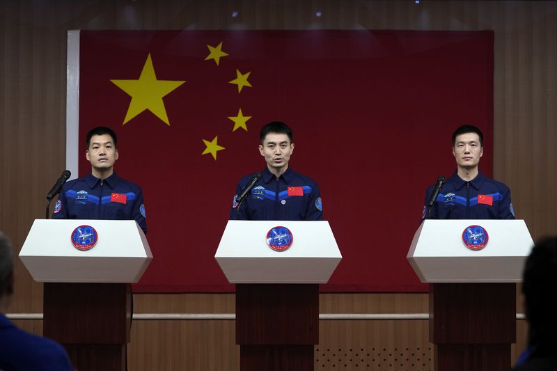 Ye Guangfu, center, with Li Guangsu, left and Li Cong, Chinese astronauts for an upcoming Shenzhou-18 mission, speaks during a meeting with the press at the Jiuquan Satellite Launch Center in northwest China, Wednesday, April 24, 2024. (AP Photo/Andy Wong)