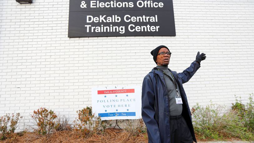 Andrew Walker, election logistics worker in Dekalb County, puts the last signs around the Voter Registration and Elections Office in Atlanta on Monday, March 2, 2020.