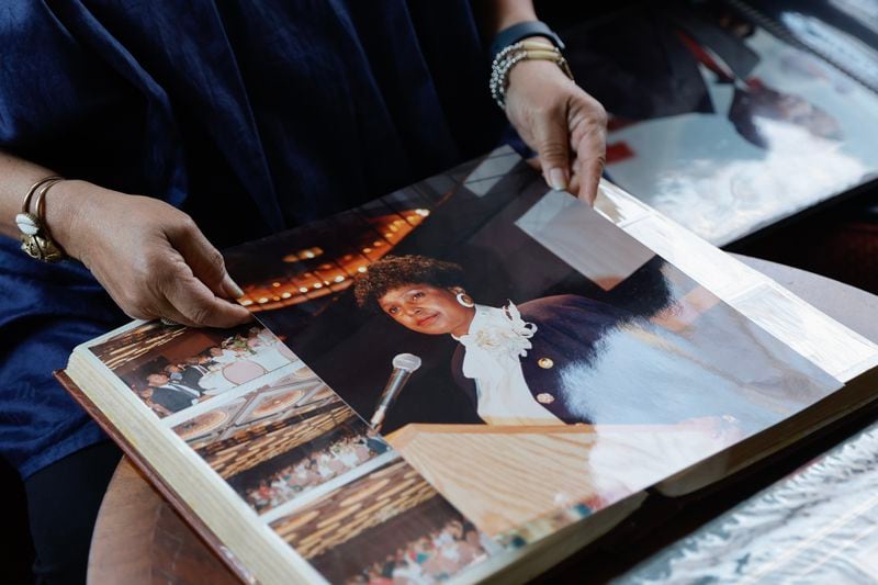 Photographer Susan “Sue” Ross holds up a photo of Winnie Mandela at Hammond’s House Museum on Friday, Feb. 2, 2024. (Natrice Miller/ Natrice.miller@ajc.com)