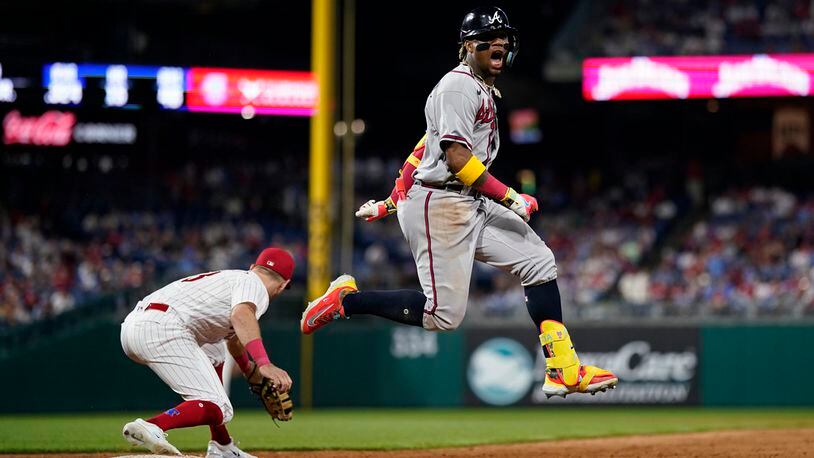 Atlanta Braves' Ronald Acuna Jr., right, reacts after beating the throw for a single past Philadelphia Phillies first baseman Kody Clemens during the ninth inning of a baseball game, Tuesday, June 20, 2023, in Philadelphia. (AP Photo/Matt Slocum)