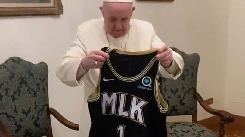 Pope Francis looks at an Atlanta Hawks MLK Day jersey before he blessed it. Photo from Atlanta Hawks / Twitter