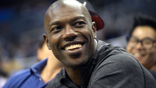 Former NFL football player Terrell Owens watches the action from court side seats during the second half of a preseason NBA basketball game between the Orlando Magic and the Memphis Grizzlies in Orlando, Fla. When Pro Football Hall of Fame voters meet the day before the Super Bowl to choose the Class of 2018, the decision to select Terrell Owens should take less than it does to microwave a bag of popcorn. T.O. belongs in Canton. It's a no-brainer.