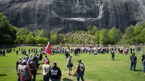 People gather on the lawn in front of the 90-foot tall carving of Stonewall Jackson, Robert E. Lee and Jefferson Davis at Stone Mountain State Park during the Sons of Confederate Veterans rally Saturday, April 30, 2022. (Photo: Steve Schaefer / steve.schaefer@ajc.com)
