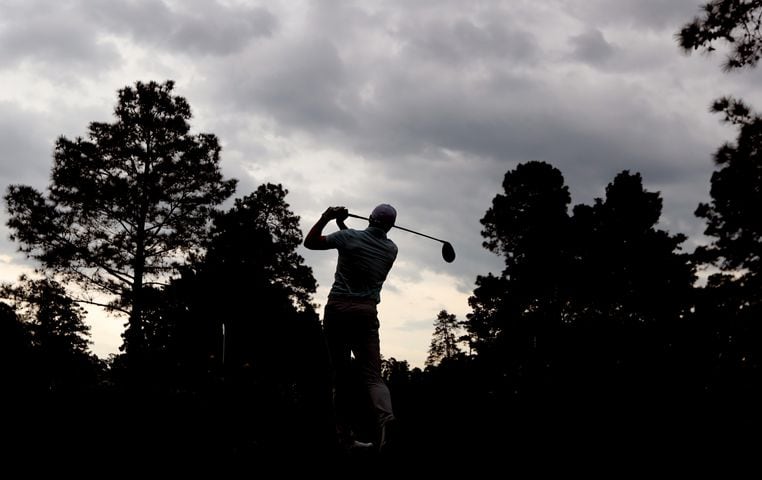 April 10, 2021, Augusta: Storm clouds pass over as play resumes and Jordan Spieth tees off on the ninth hole during the third round of the Masters at Augusta National Golf Club on Saturday, April 10, 2021, in Augusta. Curtis Compton/ccompton@ajc.com