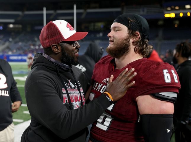 Warner Robins coach Marquis Westbrook, left, celebrates with offensive lineman Bobby Hutchinson (66) during their 62-28 win against against Cartersville in the Class 5A state high school football final at Center Parc Stadium Wednesday, December 30, 2020 in Atlanta. JASON GETZ FOR THE ATLANTA JOURNAL-CONSTITUTION