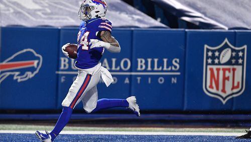 Buffalo Bills' Taron Johnson (24) returns an interception for a touchdown during the second half of an NFL divisional round football game against the Baltimore Ravens Saturday, Jan. 16, 2021, in Orchard Park, N.Y. (AP Photo/Adrian Kraus)